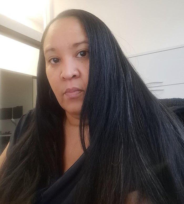 Ms. Fumiko, a Kreyòl Essence customer with long dark hair