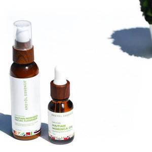 Kreyòl Essence Haitian Moringa Oil bottle for nourishing face and body skincare, with a natural, golden liquid appearance.