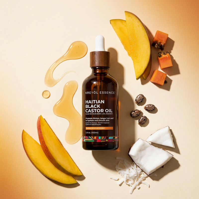 Kreyòl Essence Haitian Black Castor Oil in 3.4oz super size with mango, papaya, and coconut for hair and skin care.