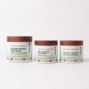 Kreyòl Essence deep conditioning hair treatment trio with three nourishing bottles in a gift set arrangement.