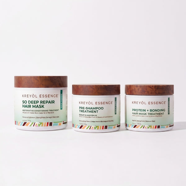 Kreyòl Essence deep conditioning hair treatment trio with three nourishing bottles in a gift set arrangement.
