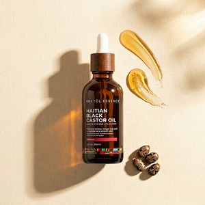 Kreyòl Essence Haitian Black Castor Oil in a 2oz bottle, natural dark oil for hair and skin care.