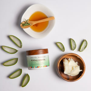 Kreyòl Essence Pomad Kreyòl Natural Scalp Balm for hair growth, 4oz, showing the balm container and herbal ingredients.