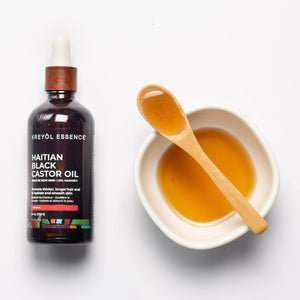 Haitian Black Castor Oil bottle by Kreyòl Essence, 3.4 oz super size, with black castor oil in a clear plastic bottle.