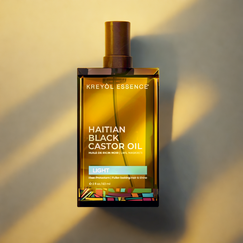 Kreyòl Essence 2oz Haitian Black Castor Oil Light hair treatment bottle with yellow label, showcasing the product's packaging.