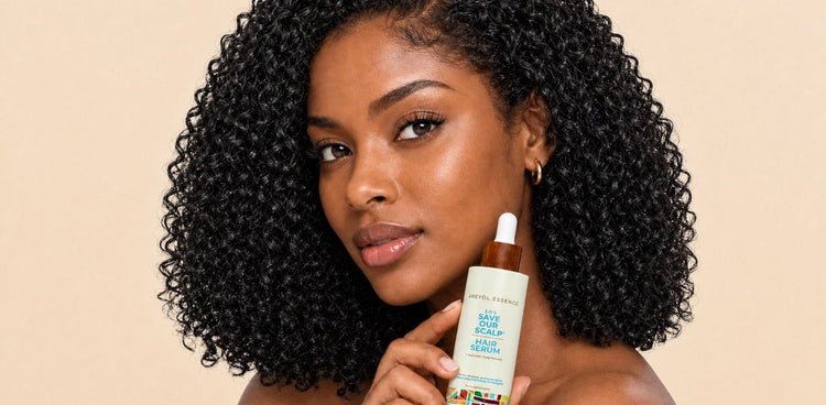 Woman holding Kreyòl Essence S.O.S Hair Serum