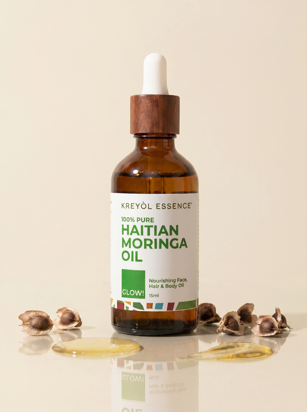 Haitian Moringa Oil by Kreyòl Essence for face and body, 3.4oz, in a clear glass bottle with dropper for nourishing skincare.