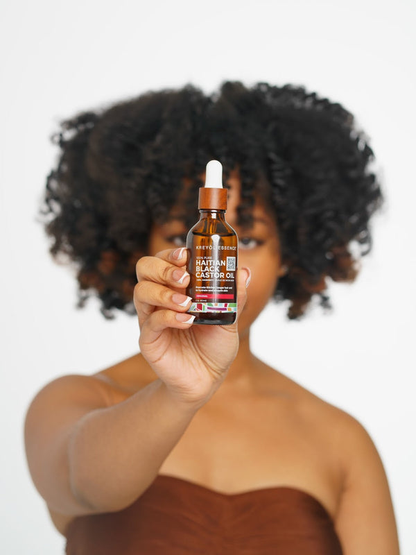 Haitian Black Castor Oil bottle from Kreyòl Essence, showcasing the original Haitian Black Castor Oil product in a clear bottle.