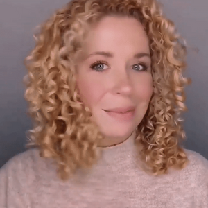 Kreyòl Essence So Smooth anti-frizz styling mousse in 8oz bottle, showing the product container and applicator nozzle.