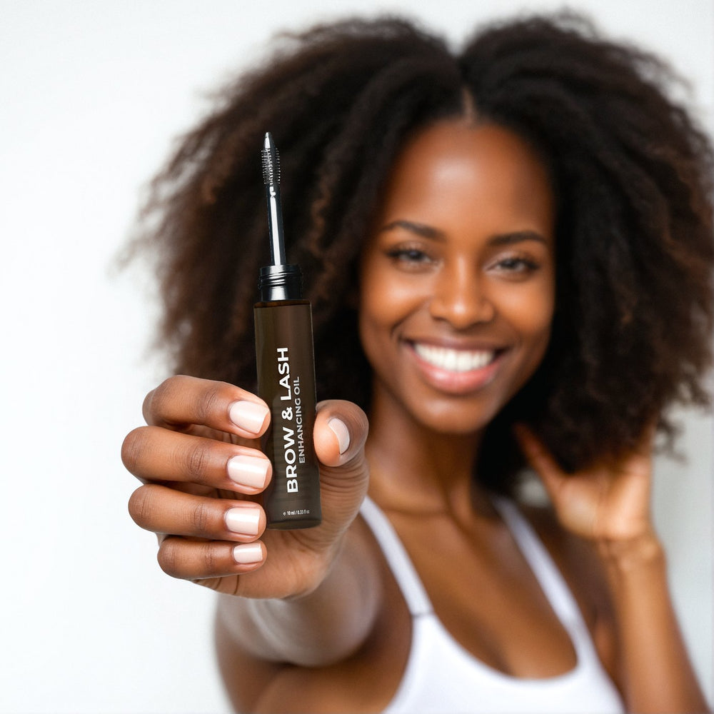 Woman holding the Kreyòl Essence Brow & Lash oil