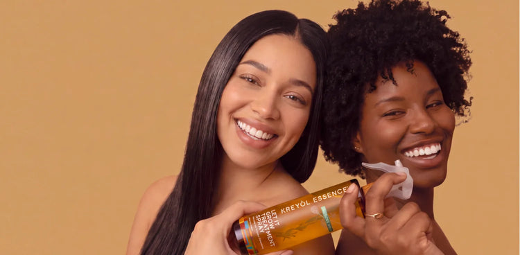 Two women smiling, one holding the Let It Grow Stronger treatment spray