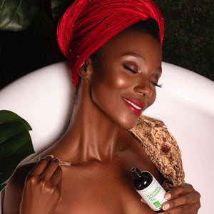 Haitian Moringa Oil by Kreyòl Essence for face and body, featuring a dark glass bottle and dropper for nourishing skin care.