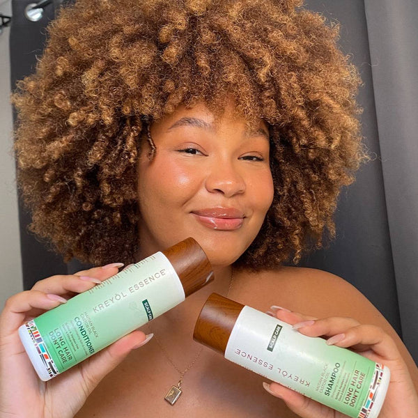 Kreyol Essence postpartum hair loss recovery kit with scalp health shampoo and conditioner for new moms' hair care.