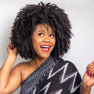 Kreyol Essence Haitian Black Castor Oil hair repair conditioner with Marley-style hair, promoting reduced shedding and healthy growth.